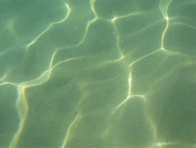Under water scene of sandy in the sea and boat