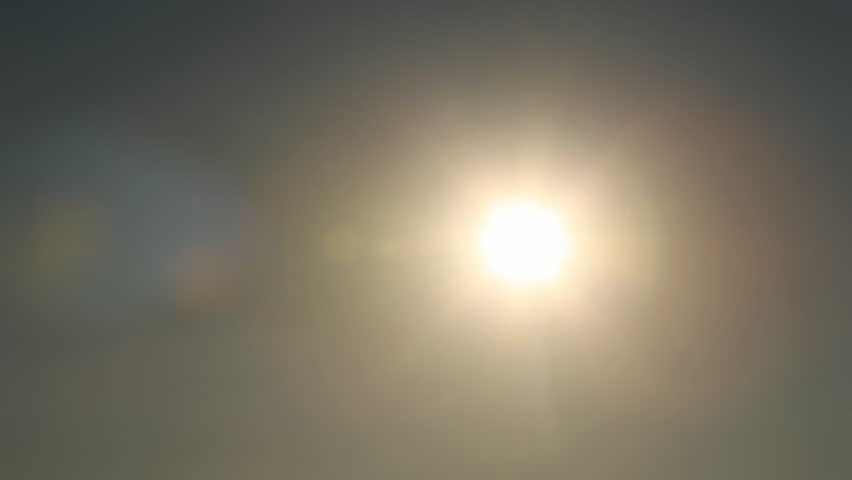 hand of child against evening sky with sun