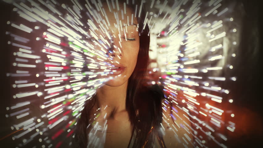 experimental stop motion clip of a beautiful woman dancing. the zoom ring of the lens is turned each time during a sequence of long exposed shot to achieve the light trails