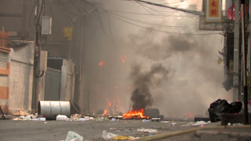 Burning street after riot conflict protest with police.