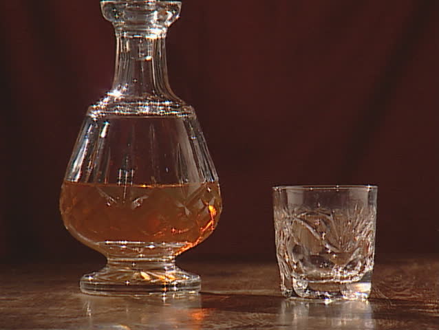 pouring whiskey into a glass