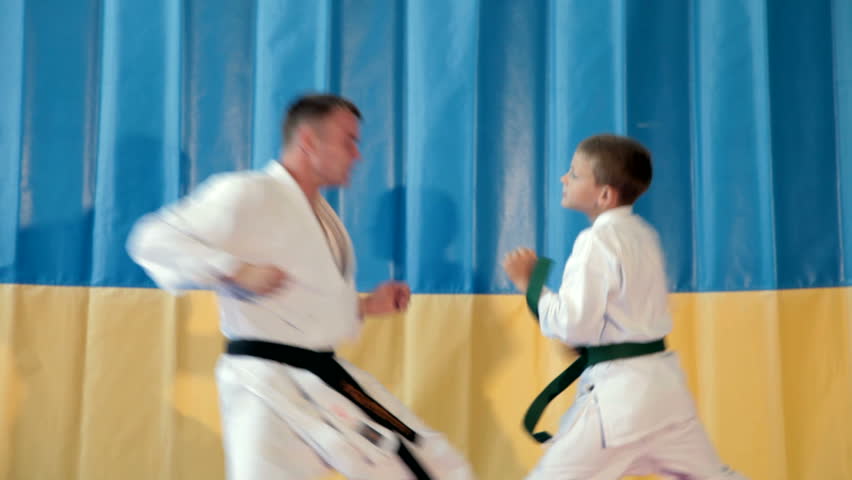 Boy learning from his karate instructor