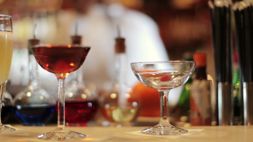 A series of model released clips featuring a female cocktail waiter in a classic looking cocktail bar in barcelona, Spain