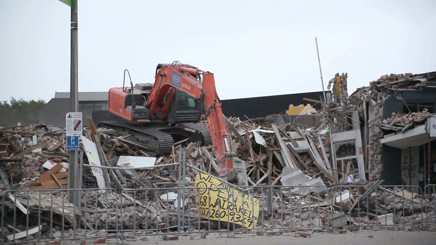 CHRISTCHURCH, NEW ZEALAND - FEB 23: A digger demolishes a local mall on the Feb 23rd, 2011. Damage caused by the Christchurch Earthquake, which devastated the city on Feb 22nd. 
