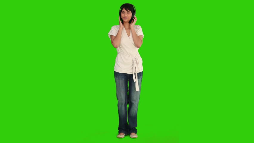 Chromakey footage of an asian woman dancing while she is listening to music
