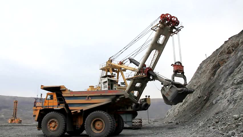 Loading the ore into heavy dump truck at the opencast mining