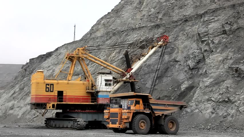 Loading the ore into heavy dump truck at the opencast mining site