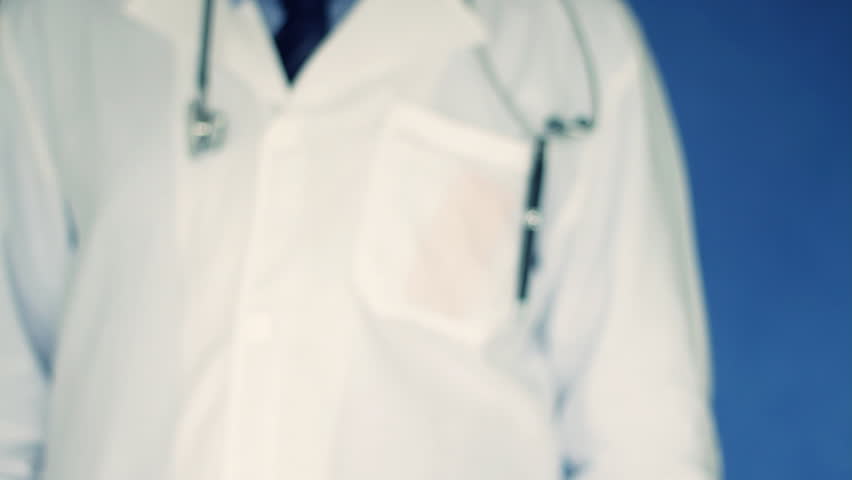 Male doctor hand offering pills in yellow blister