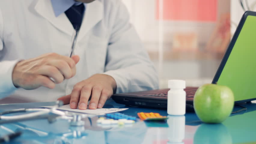 Male doctor writing rx prescription