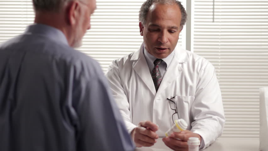 Pharmacist explaining prescription to customer, dolly shot