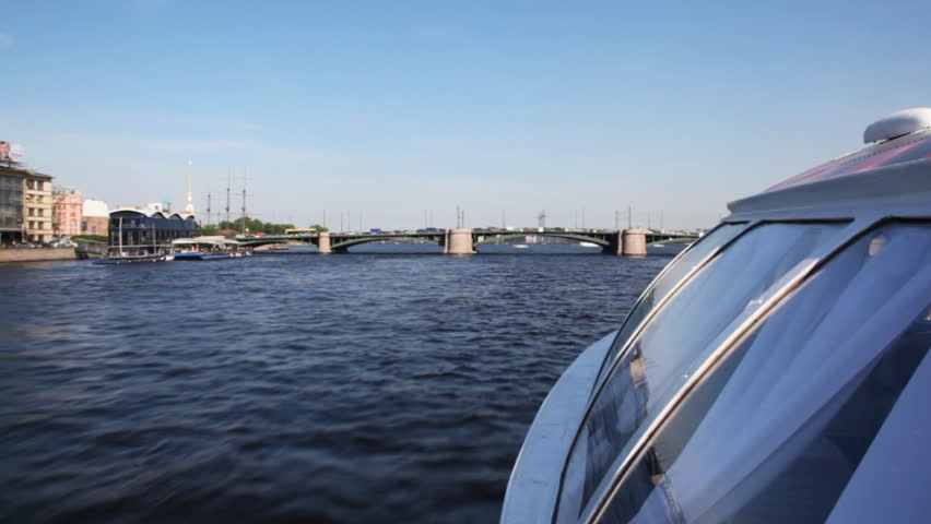 hovercraft floating rapidly under Brokerage bridge on Neva River in direction of Petropavlovskaya Fortress spring day