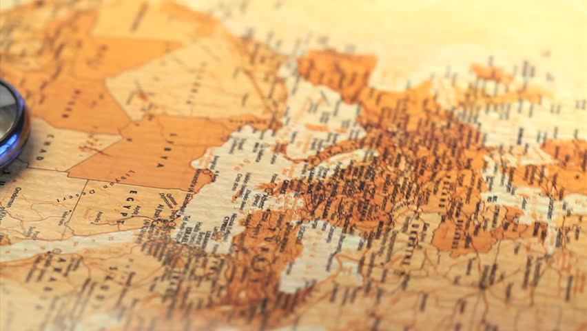 Compass raised on a worldmap