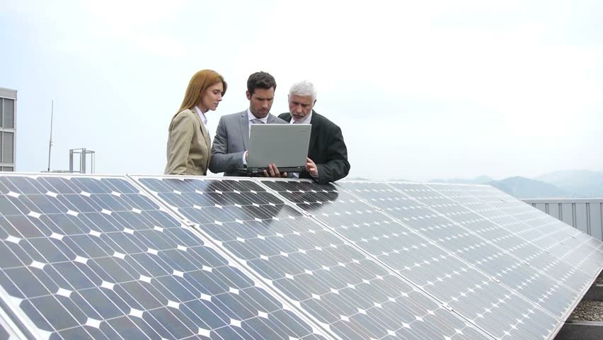 Business people standing by solar panels