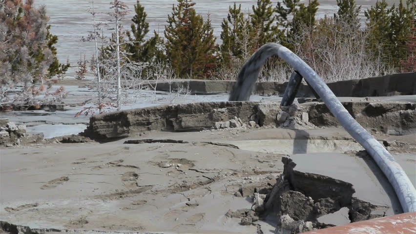 pollution spews from pipes into landscape
