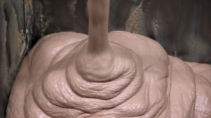 Mixing meat and spices for making hot dogs and sausages