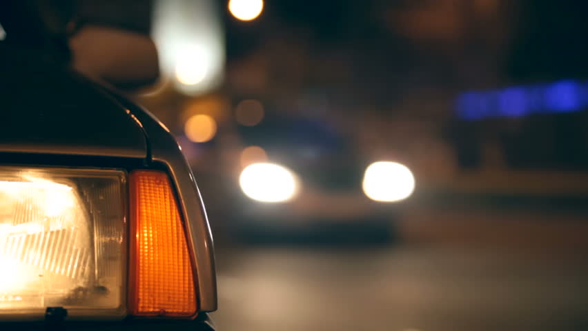 Flashing Car Hazard Lights  on urban road at night