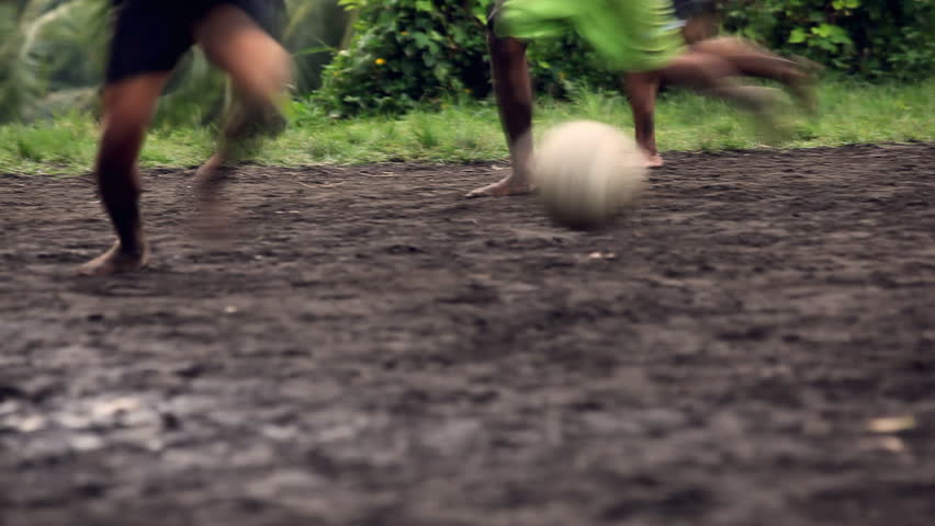 A gang of bar feet kids playing soccer on a muddy field. Serial of slow motion shots with depth of field effects. Action loaded details of running legs and goal shots. [b]HD1080 | 30fps[/b]