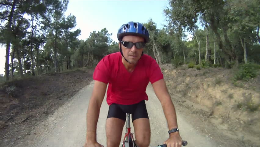 Man cycling along trail on mountain bike