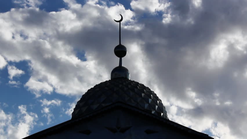 Fast clouds timelapse crossing behind a mosque minaret.