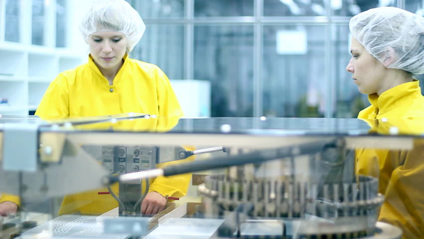 Two pharmaceutical technicians having a conversation at workplace. Selective Focus. HD 1080i.