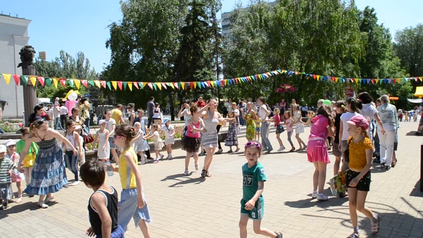 DONETSK, UKRAINE - MAY 29: Children dance in a circle with  parents in celebration of Children's Day, May 29, 2011 in Donetsk, Ukraine. First proclaimed by the United Nations General Assembly in 1954, Children's Day is observed around the world. 