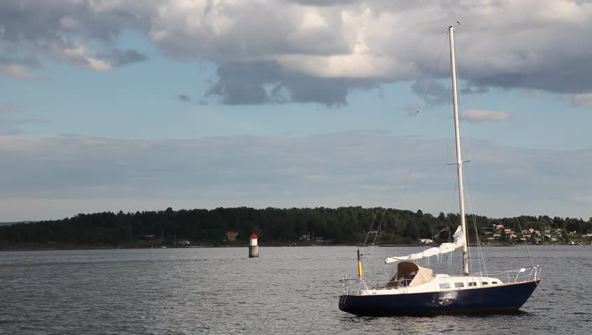 Sail boat parked in Oslo fjord with fjord traffic in behind Full HD