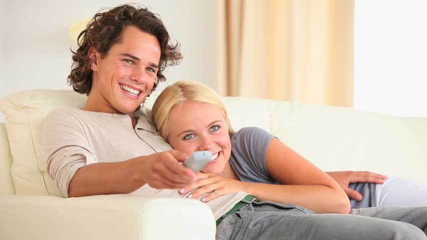 Cute couple watching TV in the living room