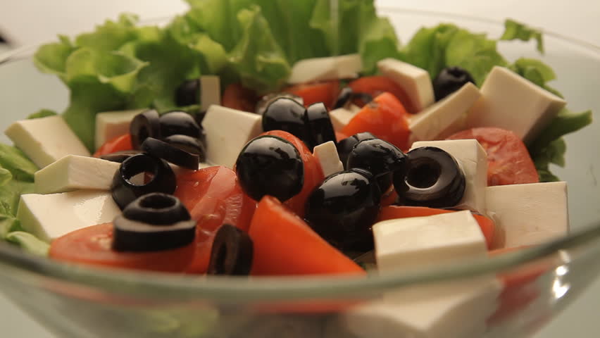 Pour vegetable salad with olive oil