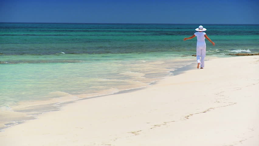 Elegant young female reveling in achieving her fantasy of a luxury island vacation