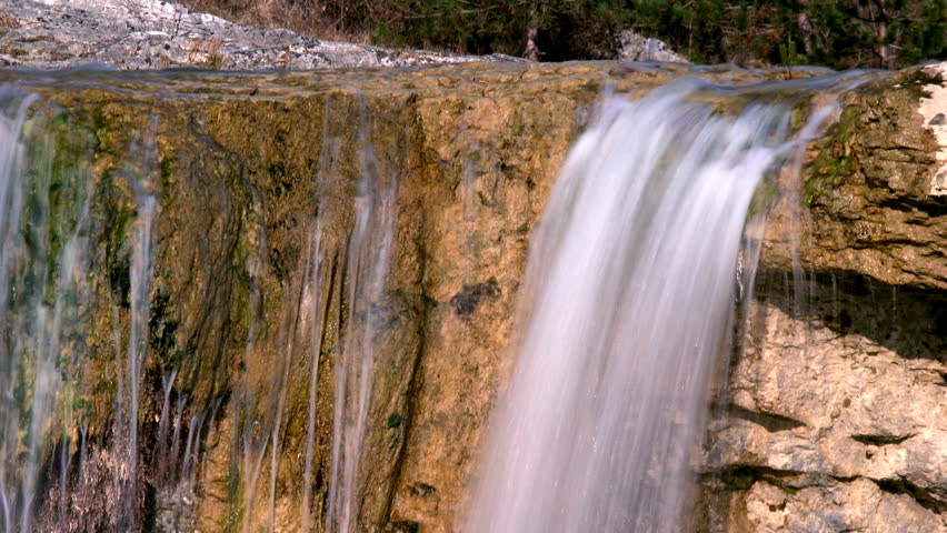 Water falling over a golden rock in Zarecki krov, loopable