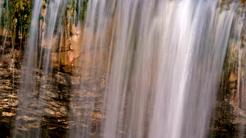 River falling  in a cascade over a golden rock in Zarecki krov