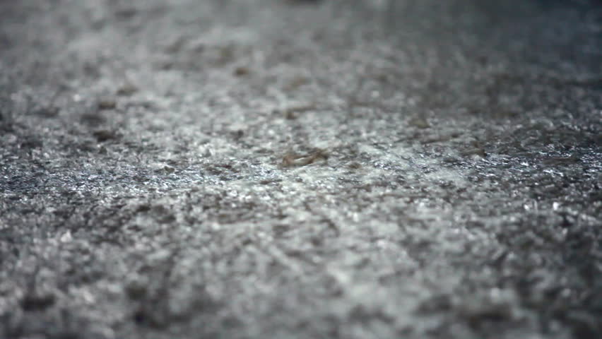Rainwater flowing down  of a street after a storm