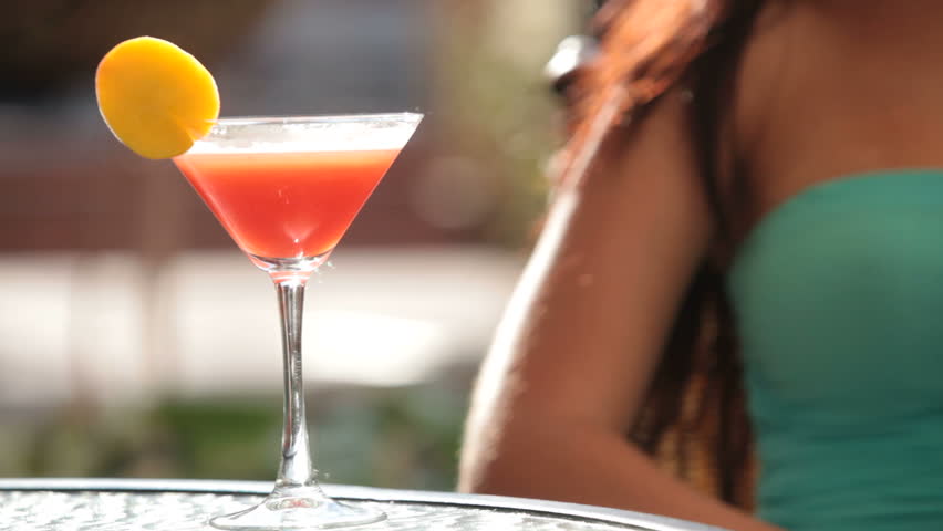 Unrecognizable girl is holding a glass of alcoholic beverage