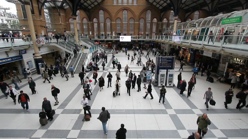 LONDON, UK - JULY 25: Train travelers walk through the central hall of Liverpool Street Station on July 25, 2011 in London, UK. Liverpool Street Station is the third busiest railway station of London.