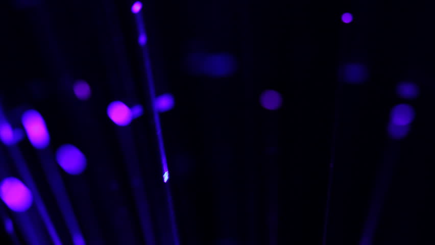 Close up of optical fiber light that is turning around. Suitable for technology and science concepts.