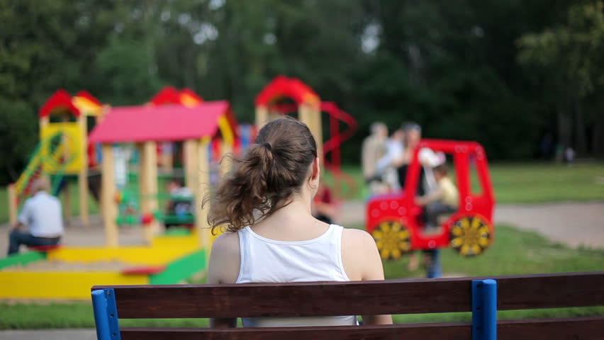 Young woman looking at a playground