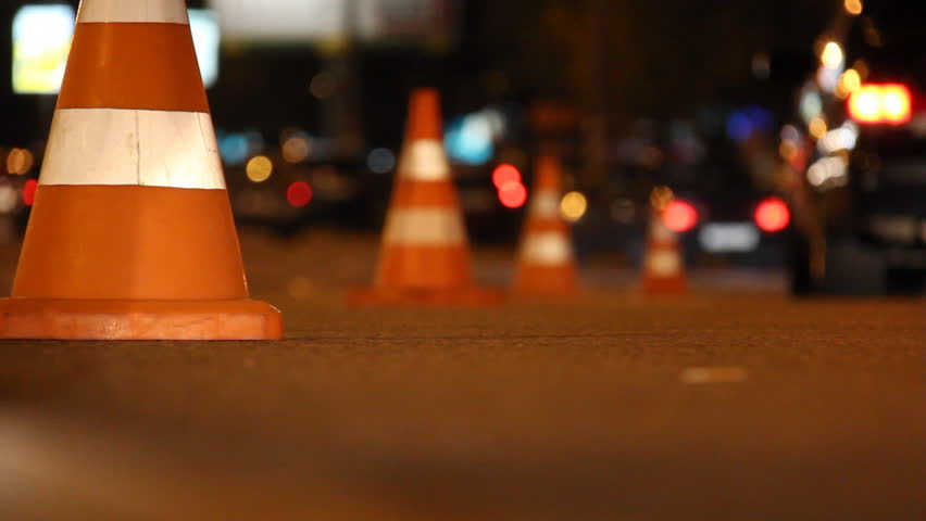 traffic cones exhibited in the line of the roadway and their cars go round