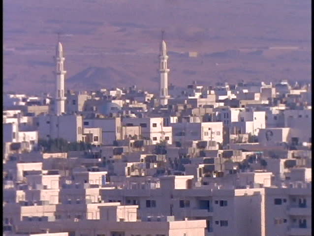 Minarets tower over the white buildings of Aqaba, Jordan.