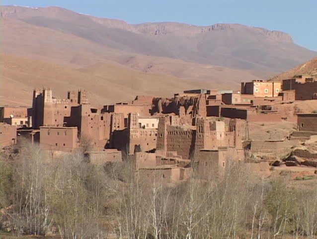 Adobe buildings crowd close together on a hillside.