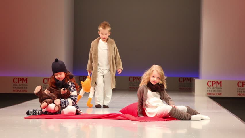 MOSCOW - FEB 22: Boy walk and girls sit in clothes from Mayoral Collection, Collection Premiere Moscow, on Feb 22, 2011 in Moscow, Russia. The company Mayoral Moda Infantil was founded in early 1970s.