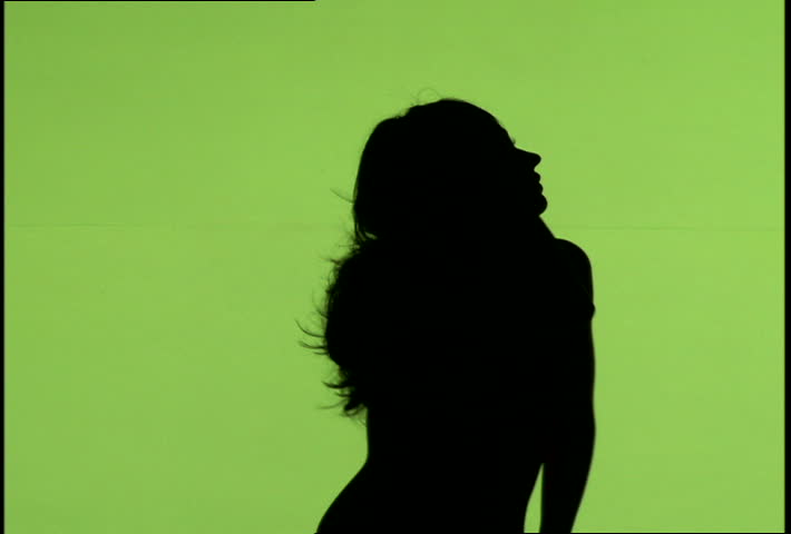 A woman's silhouette dancing against green background