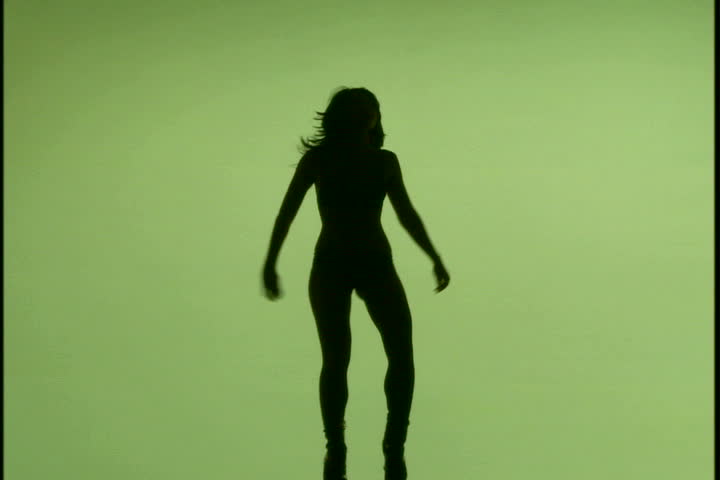 A woman's silhouette dancing against green background