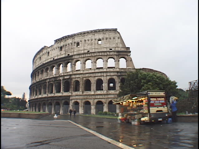 A vendor sells souvenirs next to the Coliseum in Rome.