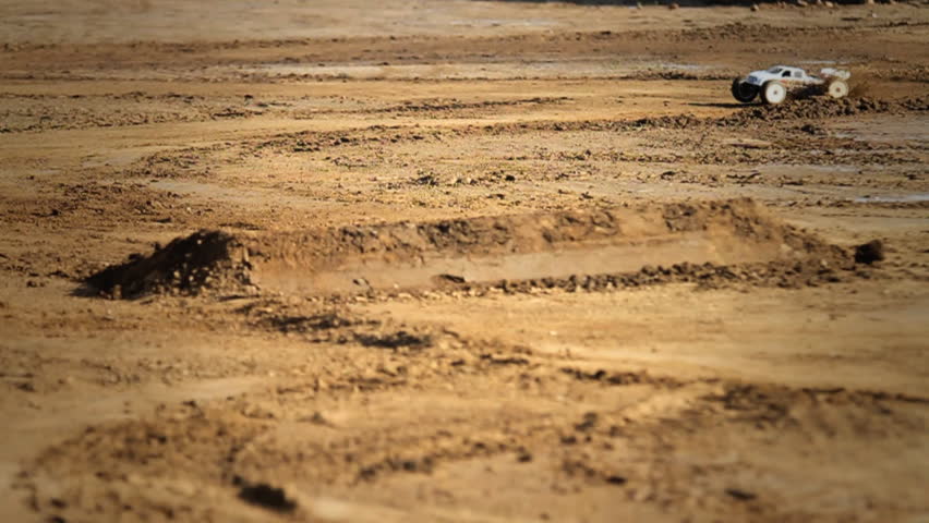 RC car drifting around dirt (slow motion)