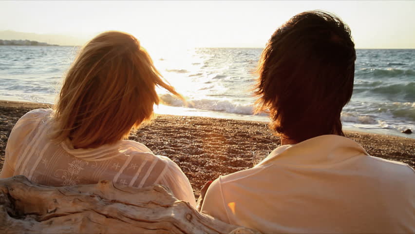 happy couple chilling out in the sunset
