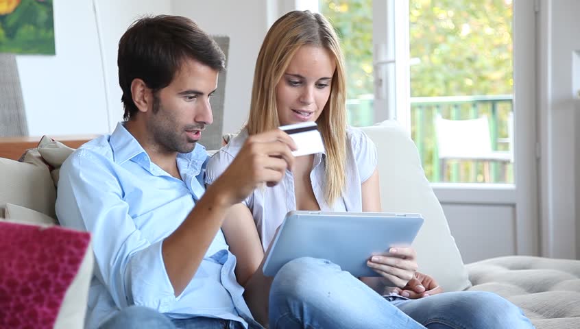 Young couple at home doing online shopping