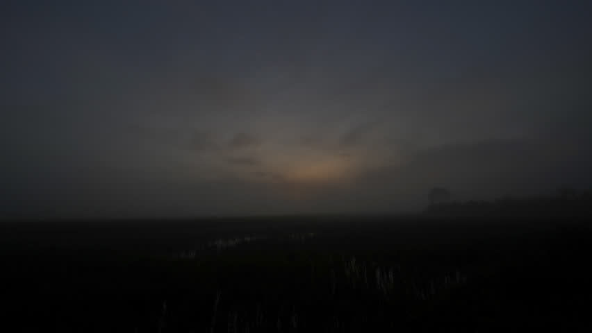 time lapse sunrise over foggy rice field