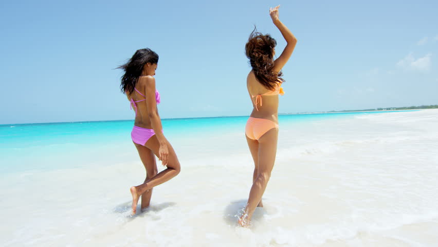 Happy Bikini Woman Jumping Of Joy And Success On Perfect White Sand