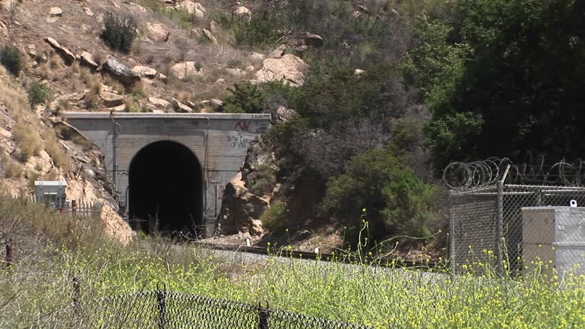 A Amtrak passenger train passes through a hillside tunnel near Los Angeles.