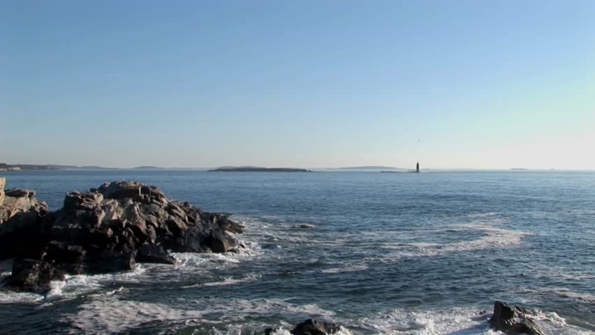The Portland Head Lighthouse oversees the ocean from rocks in Maine, New England. 